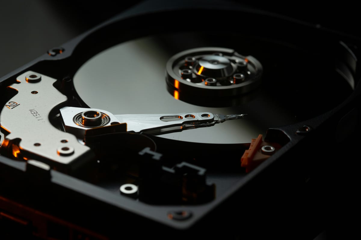 A hard drive being handled, representing secure data destruction.